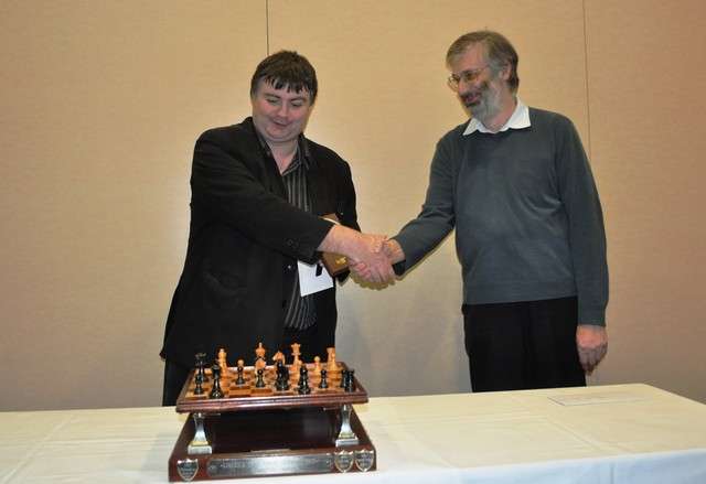 Irish champion FM Colm Daly receiving the first prize and perpetual trophy from ICU Chairman Pete Morris